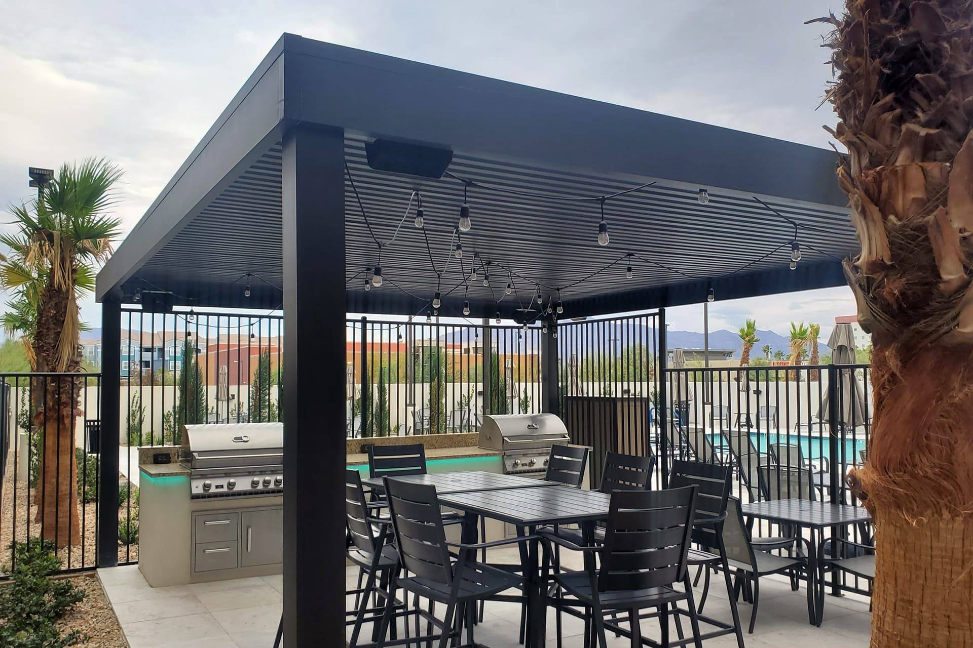 A commercial patio cover in the style of a pergola, with dining and outdoor dining appliances underneath