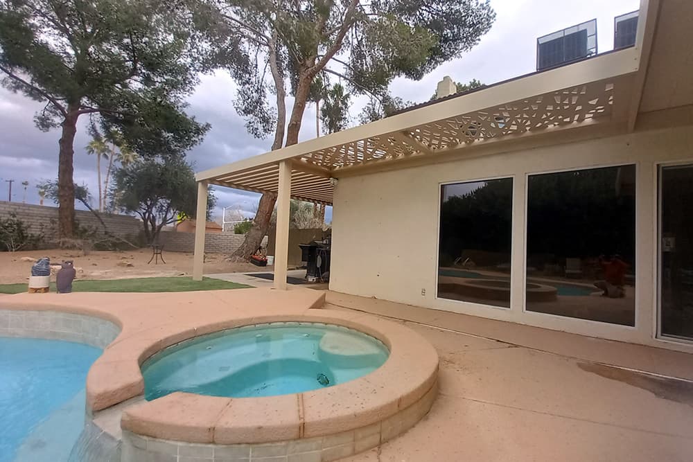 A pool a hot tub area with an open lattice 4K Aluminum patio cover