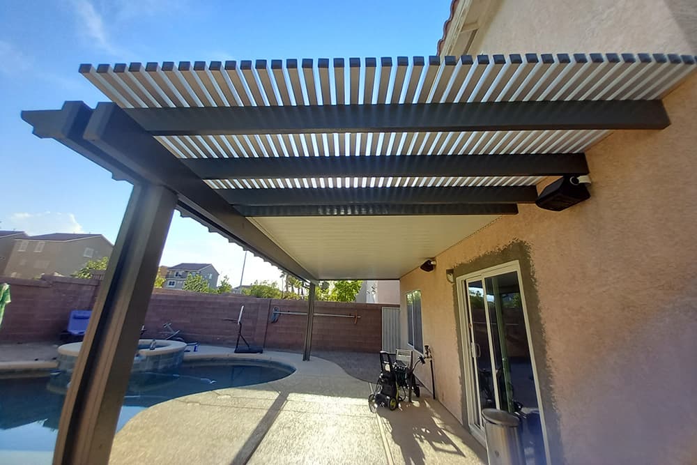 A Las Vegas backyard with a pool and solid/lattice combo patio cover