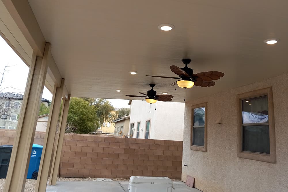 An insulated patio cover with lights and fans installed