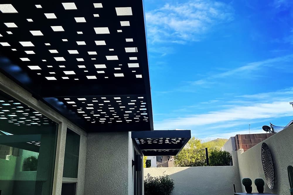 An open lattice patio cover with geometric openings for sunlight