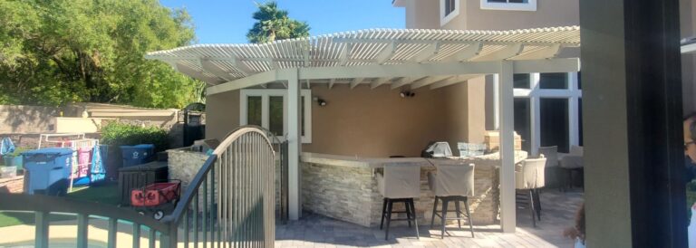 A small patio with a lattice patio cover over a bar.
